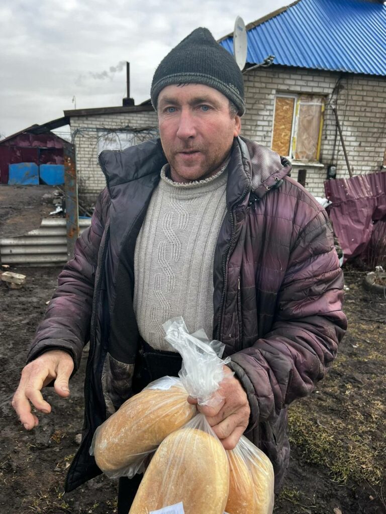 поліціянти дають людям хліб на Луганщині