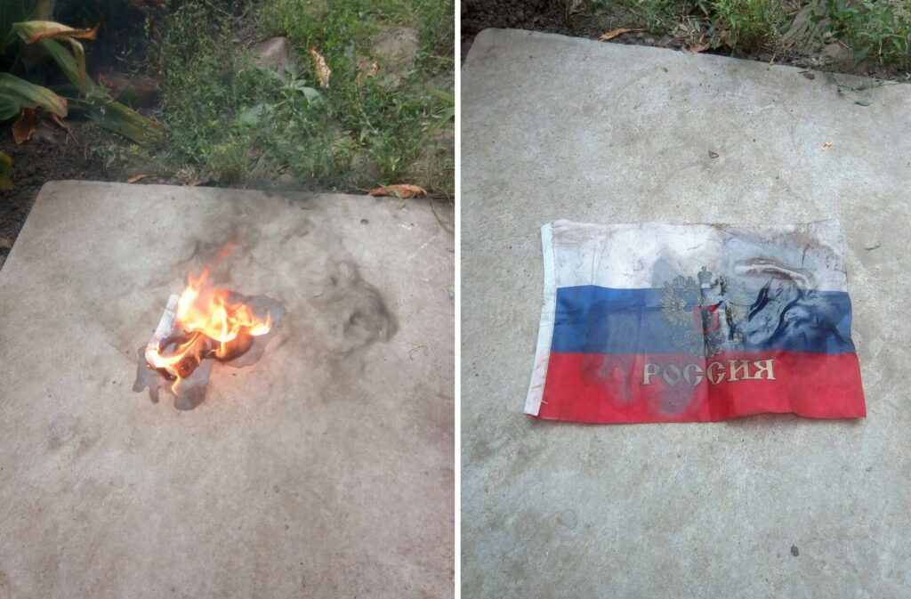 Жителі Луганська спалюють агітаційний матеріал та зривають прапор росіян